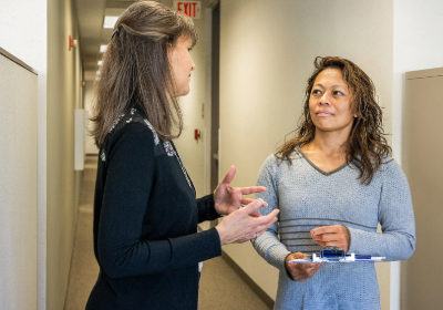 Two public health employees in conversation