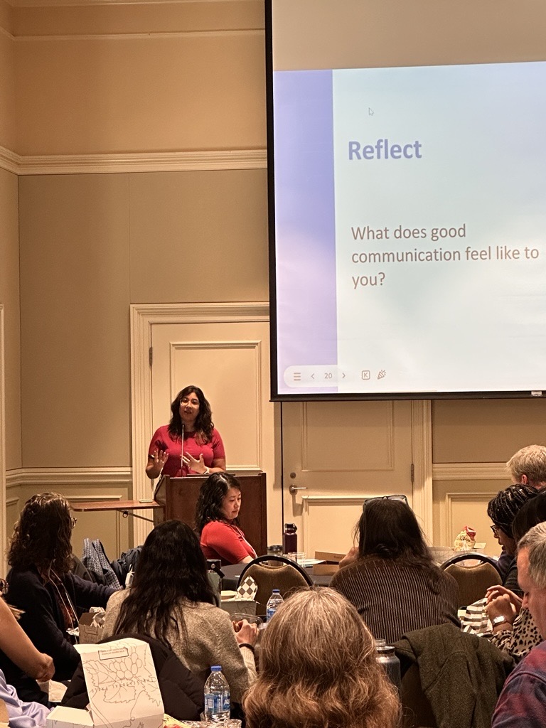 de Beaumont staff speaking to a group of Talking Health Training attendees in person